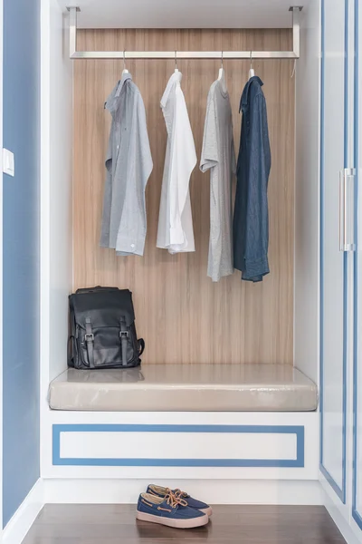 Ρούχα κρεμάσει rail σε ξύλινη ντουλάπα με μαύρη τσάντα — Φωτογραφία Αρχείου