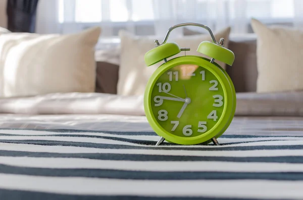 Modern green alarm clock in bedroom — Stock Photo, Image