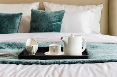 tea set on black tray in bedroom clipart