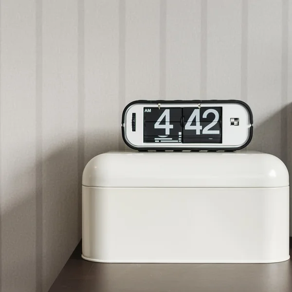 Modern alarm clock on white plastic box — Stock Photo, Image