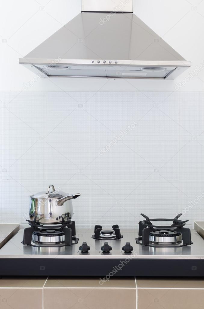 stainless pan on gas stove with hood
