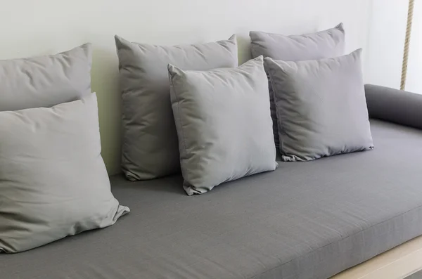 Almohadas en sofá cama gris —  Fotos de Stock