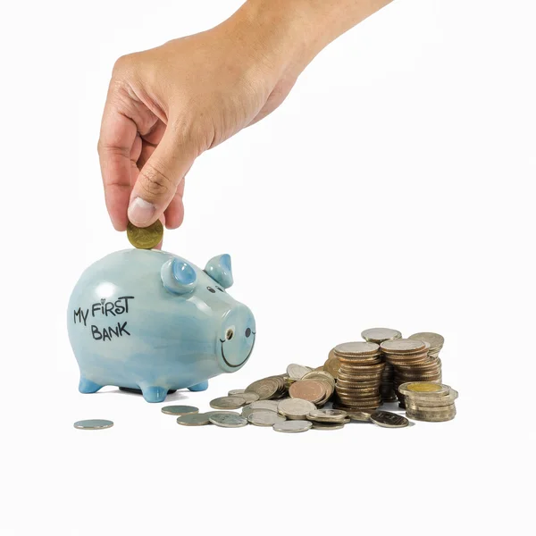 Piggybank och mynt med hand — Stockfoto