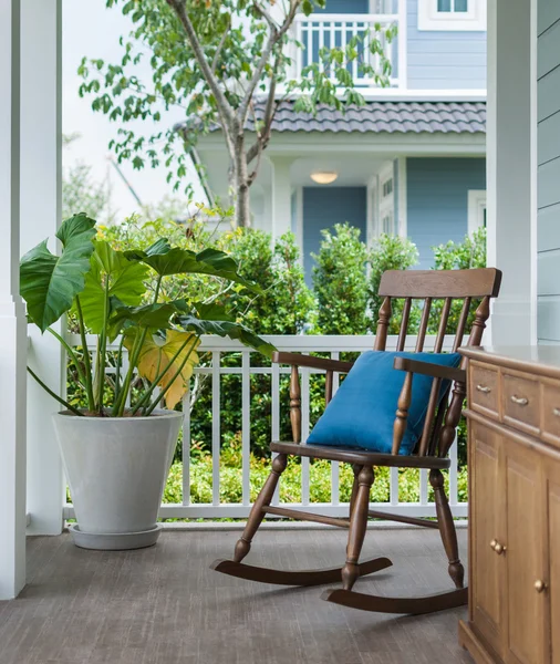 Wooden rocking chair on front porch with pillow — Stock Photo, Image