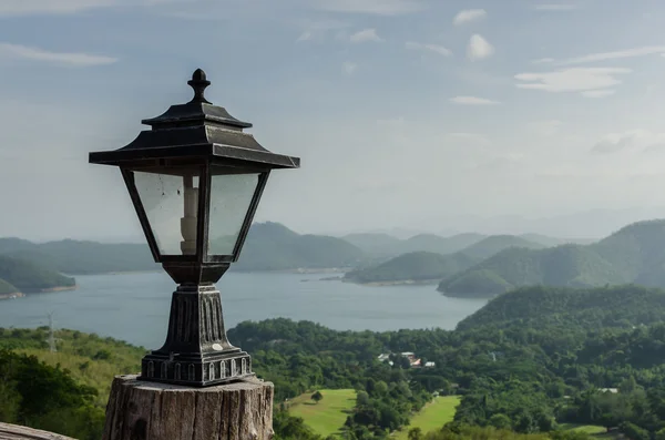 Old lamp with lake and mountains — Stock Photo, Image