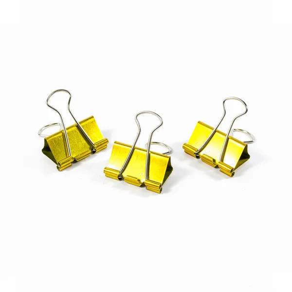 Three of gold color binder clips isolated — Stock Photo, Image