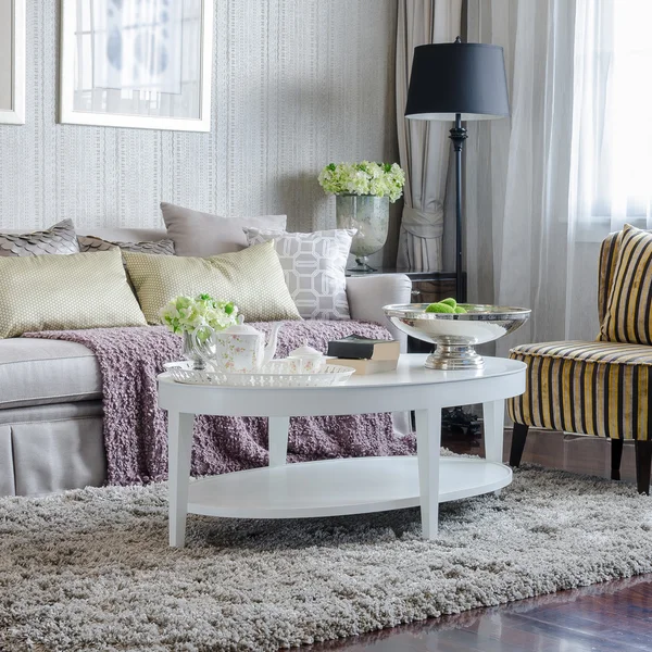 Luxury living room with sofa and white table on carpet — Stock Photo, Image