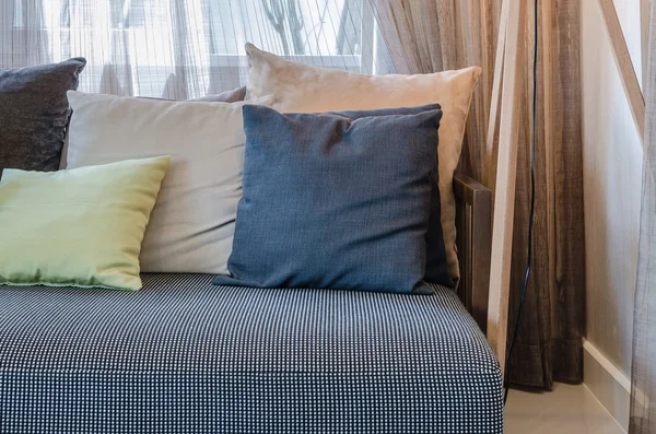 Pillows on modern black sofa in living room — Stock Photo, Image