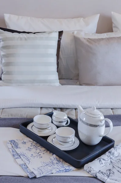 Tea cup set on black tray in bedroom — Stock Photo, Image