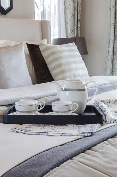 Tea cup set on black tray in bedroom — Stock Photo, Image