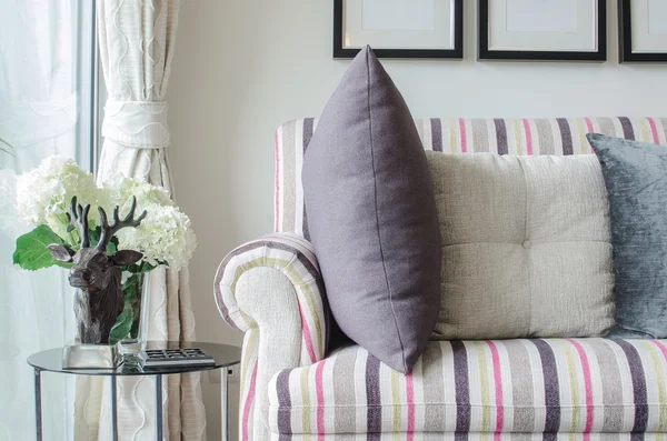 Colorful sofa with pillows and glass table in living room — Stock Photo, Image