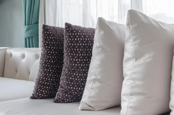 Row of pillows on white modern sofa — Stock Photo, Image