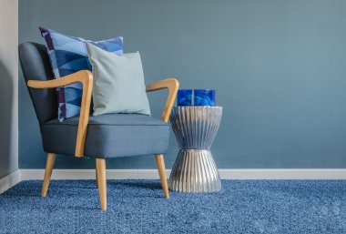 Wooden chair with blue color pillow