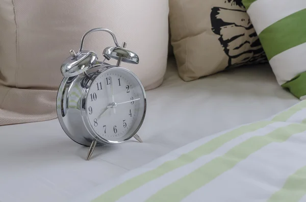 Modern alarm clock on white table in bedroom — Stock Photo, Image