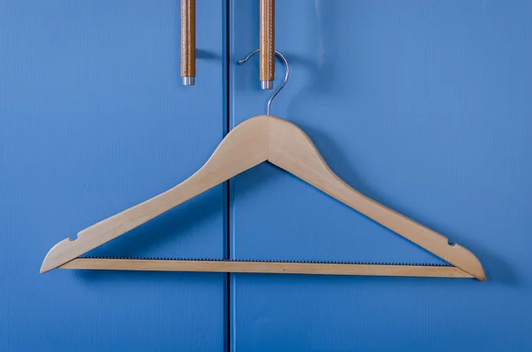Wooden cloth hanger hanging on door handle — Stock Photo, Image