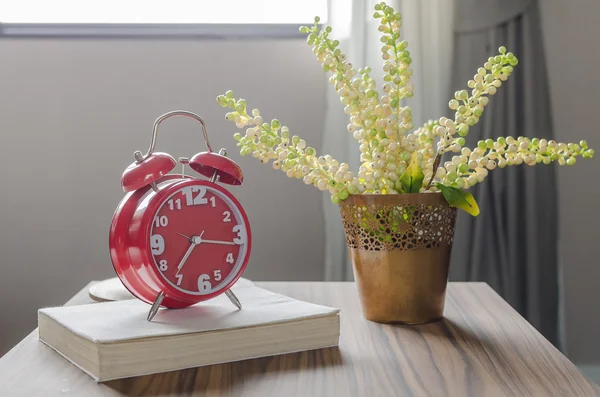 Red alarm clock on book — Stock Photo, Image