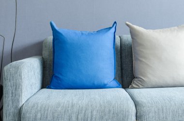modern green sofa with blue and grey pillows