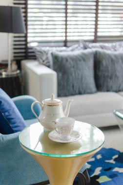 pillows on blue sofa with lamp