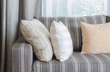 pillows on blue sofa with lamp