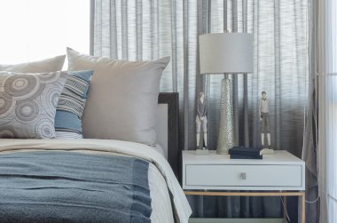 pillows on blue sofa with lamp