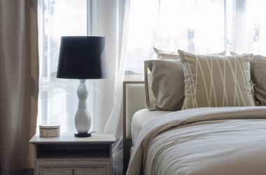 pillows on blue sofa with lamp