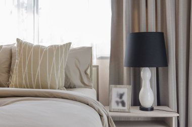 pillows on blue sofa with lamp