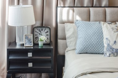 pillows on blue sofa with lamp