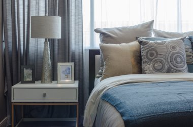 pillows on blue sofa with lamp