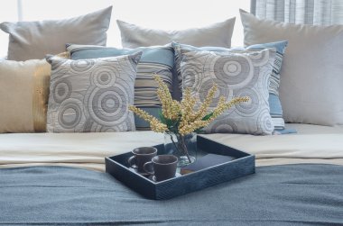 pillows on blue sofa with lamp