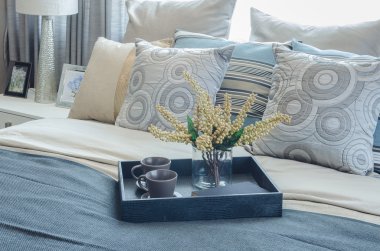 pillows on blue sofa with lamp