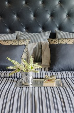 pillows on blue sofa with lamp