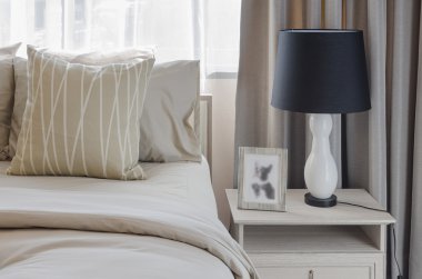 pillows on blue sofa with lamp