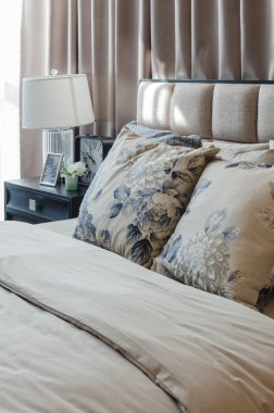 pillows on blue sofa with lamp