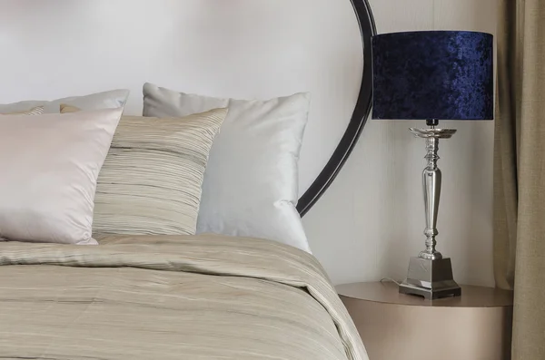 Pillows on blue sofa with lamp — Stok fotoğraf