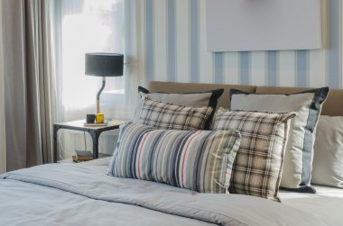 pillows on blue sofa with lamp