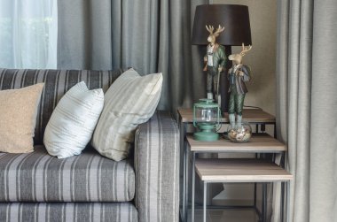 pillows on blue sofa with lamp