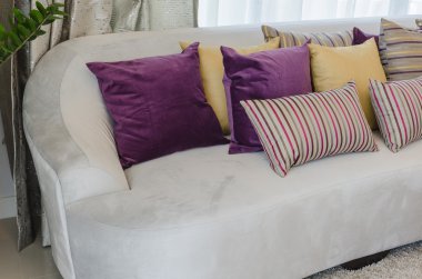 pillows on blue sofa with lamp