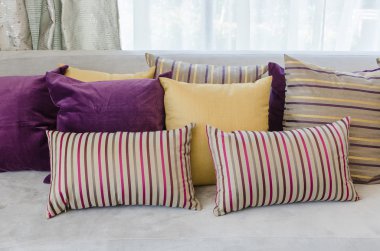 group of colorful pillows on sofa in living room