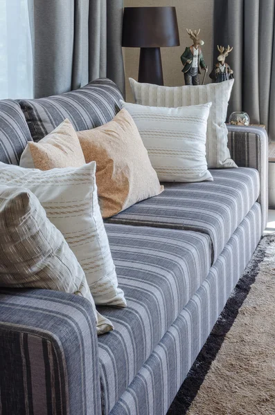 Pillows on blue sofa with lamp — Stock Photo, Image