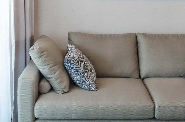 Pillows on blue sofa with lamp — Stockfoto