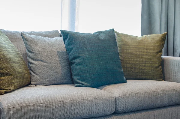 Pillows on blue sofa with lamp — Stok fotoğraf