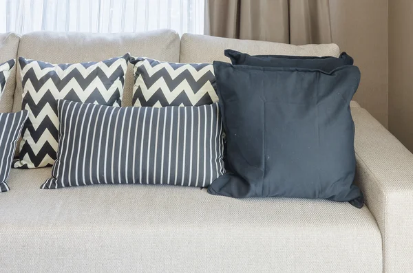 pillows on blue sofa with lamp