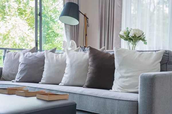 Row of pillows on modern grey sofa — Stock Photo, Image