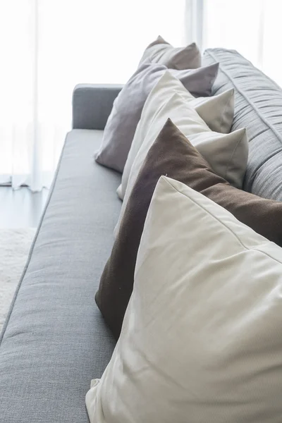 Row of pillows on modern grey sofa — Stock Photo, Image