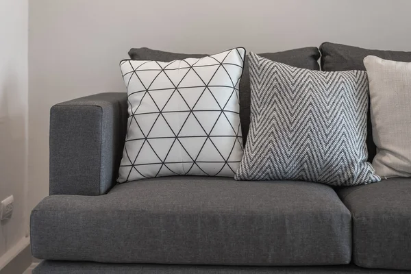 Graphic pattern pillows on modern grey sofa — Stock Photo, Image