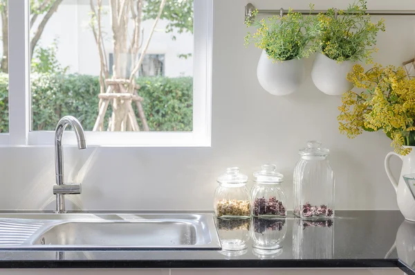 Modern sink on black kitchen counter — Stock Photo, Image