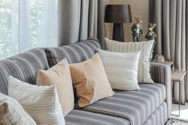 Row of pillows on modern grey sofa — Stock Photo, Image