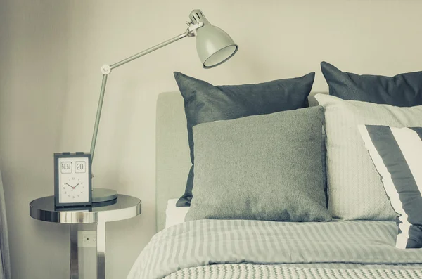 Modern bedroom with modern grey lamp and clock on table side — Stock Photo, Image