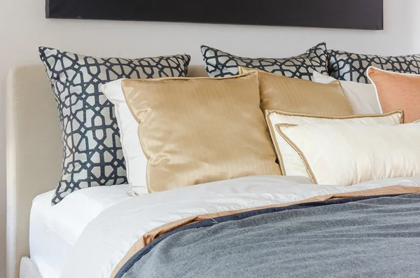 Pillows on modern bed with grey blanket — Stock Photo, Image