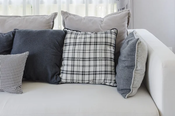 Pillows on modern white sofa in living room — Stock Photo, Image